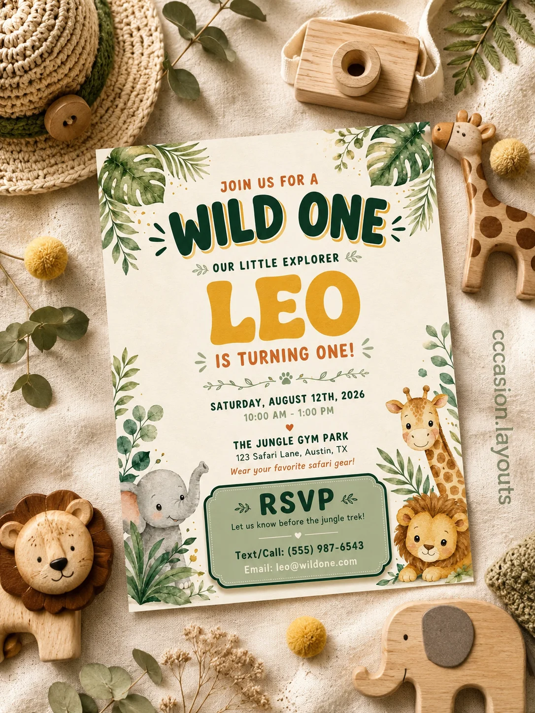Kids jungle safari birthday invitation with watercolor leaves, cute safari animals, and a playful Wild One theme in a cozy flat-lay setting.